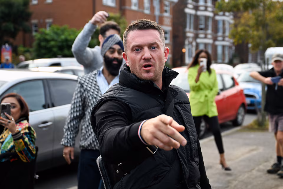 Tommy Robinson Charged with Harassing Journalists Amid Early Prison Release